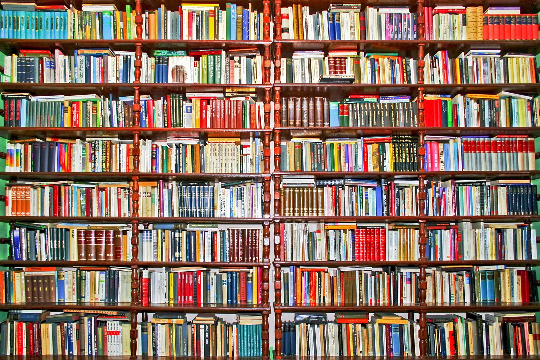 Close-up view of bookshelves in a library filled with various colorful books neatly arranged.