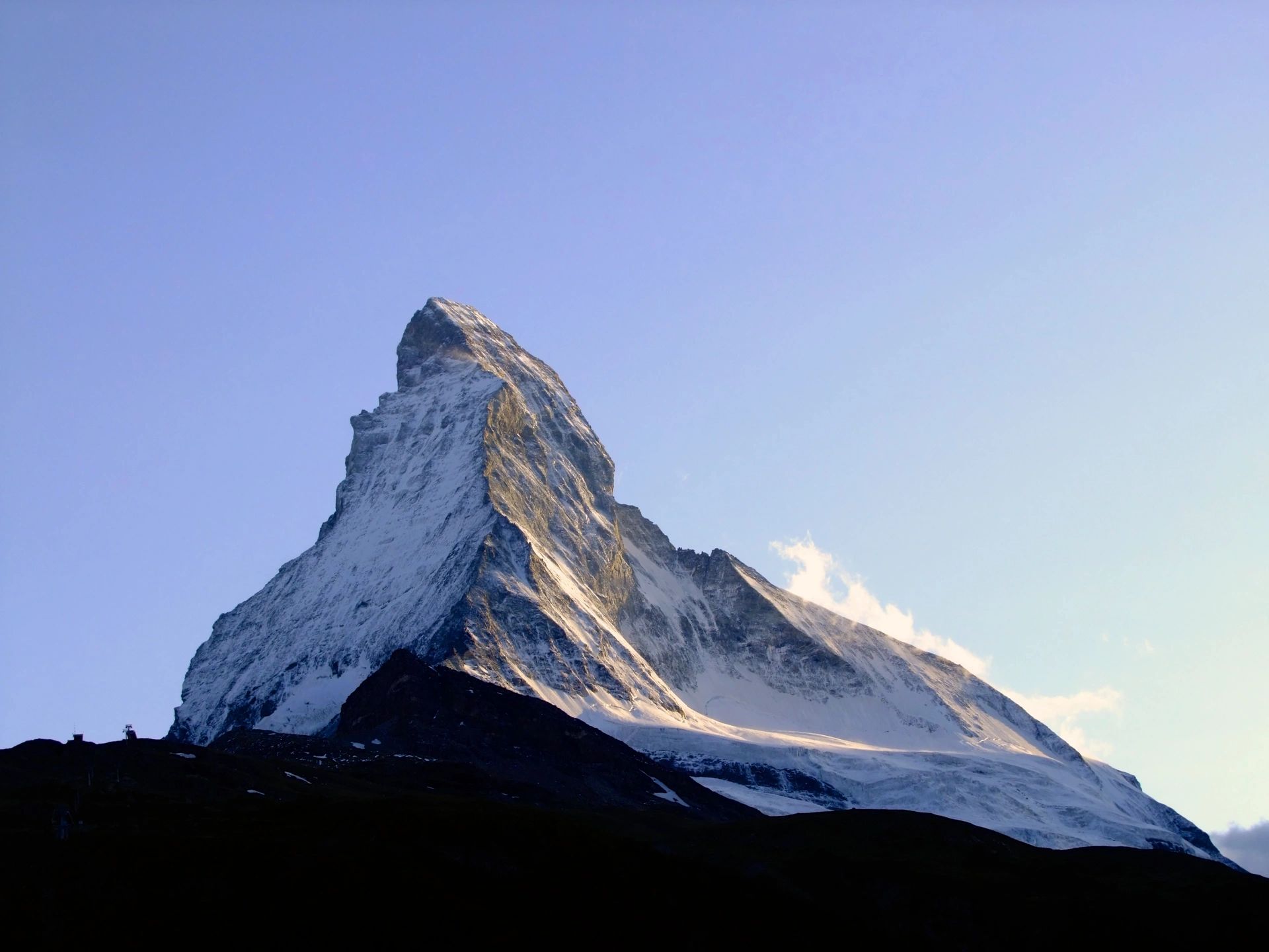 A majestic mountain peak surrounded by clouds, symbolizing achievement and reaching new heights.