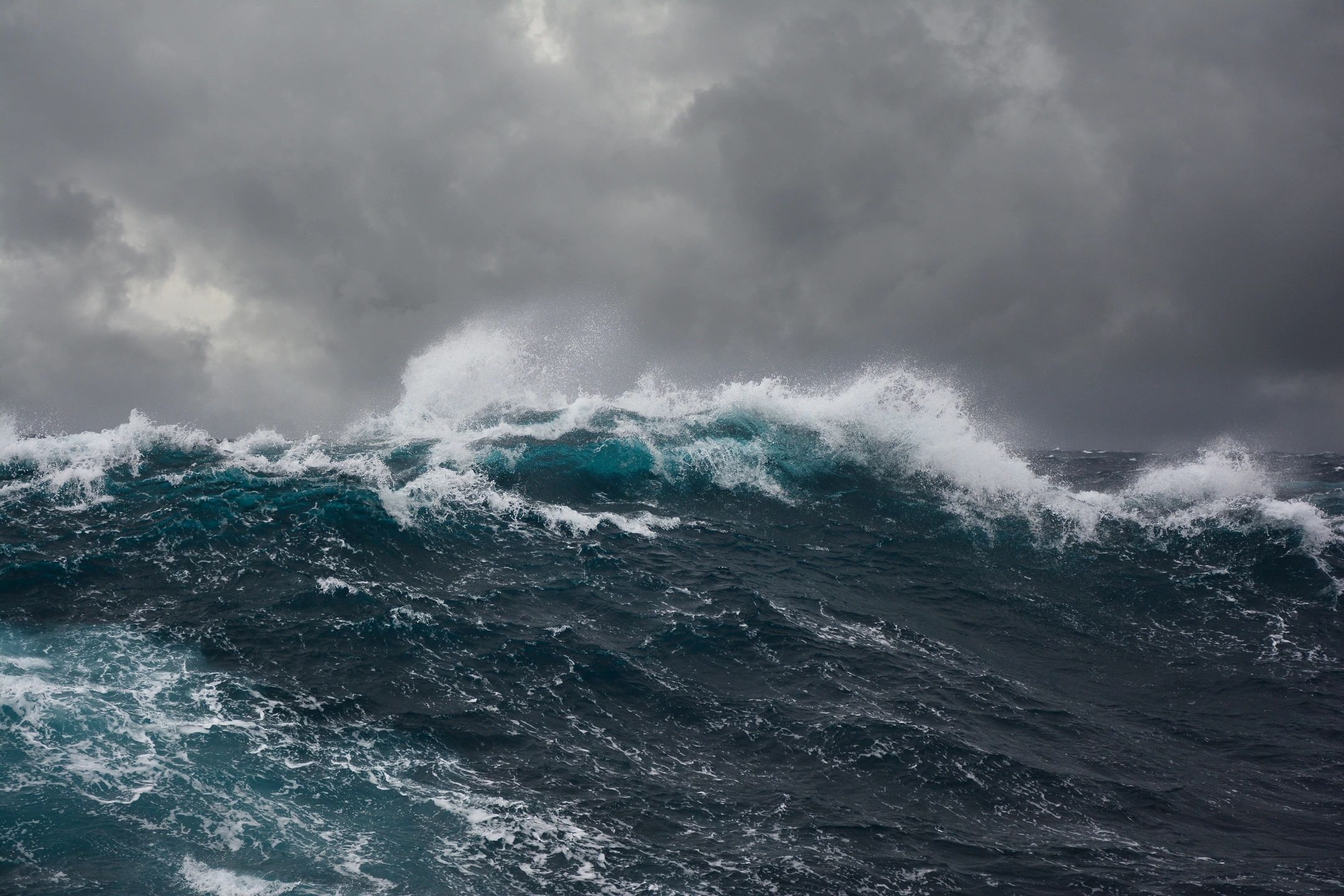 A powerful crashing wave in the ocean, symbolizing strength and natural energy.